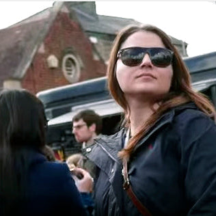 woman in sunglasses walking down Mill Road